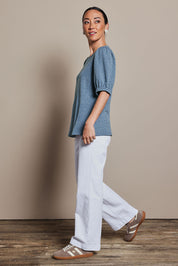 Model Katie wearing size 10 of the Gathered Sleeve Top in colour Denim (Blue), from the front, showing the whole outfit