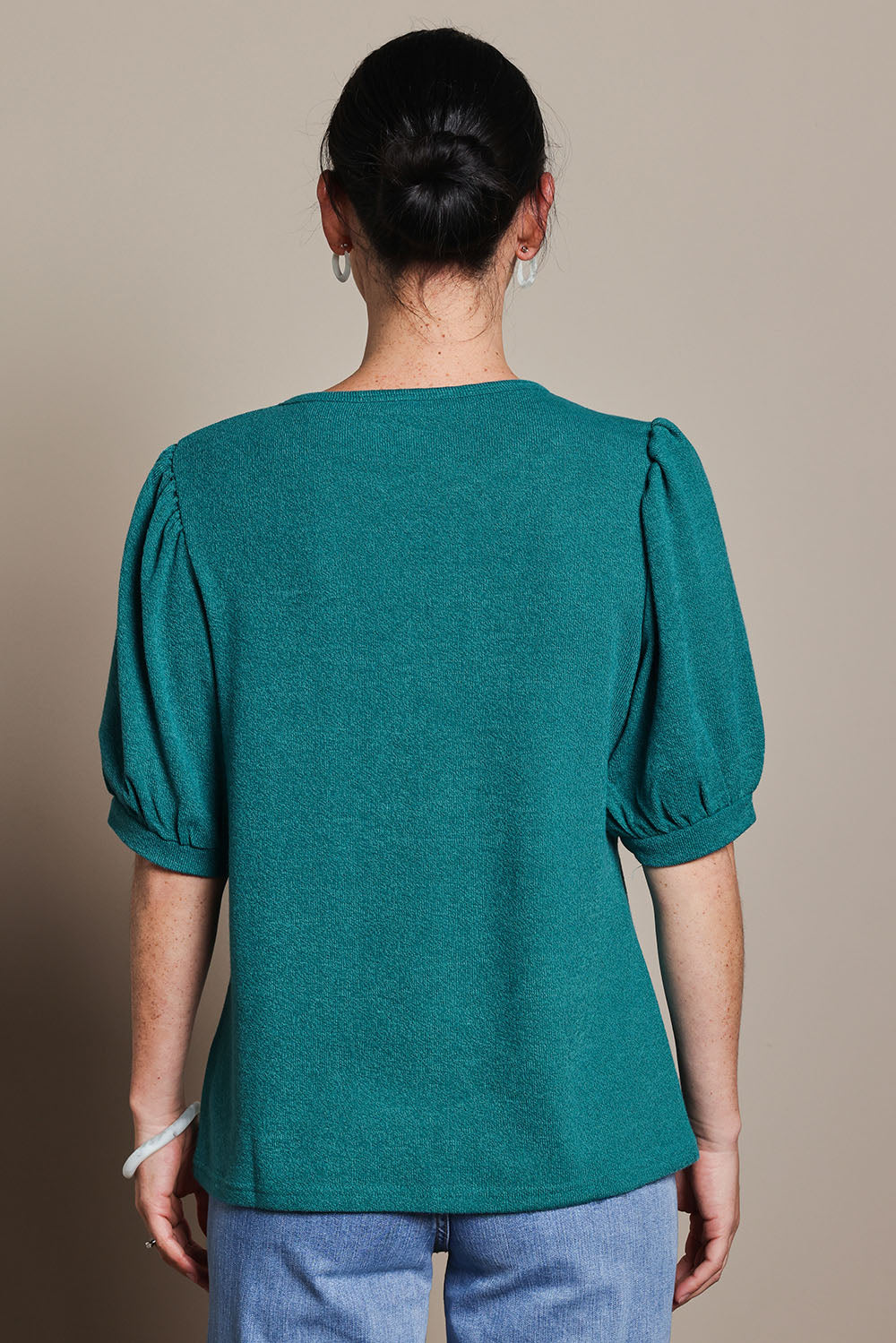Model Katie wearing size 10 of the Gathered Sleeve Top in colour Jade (Green), from the back