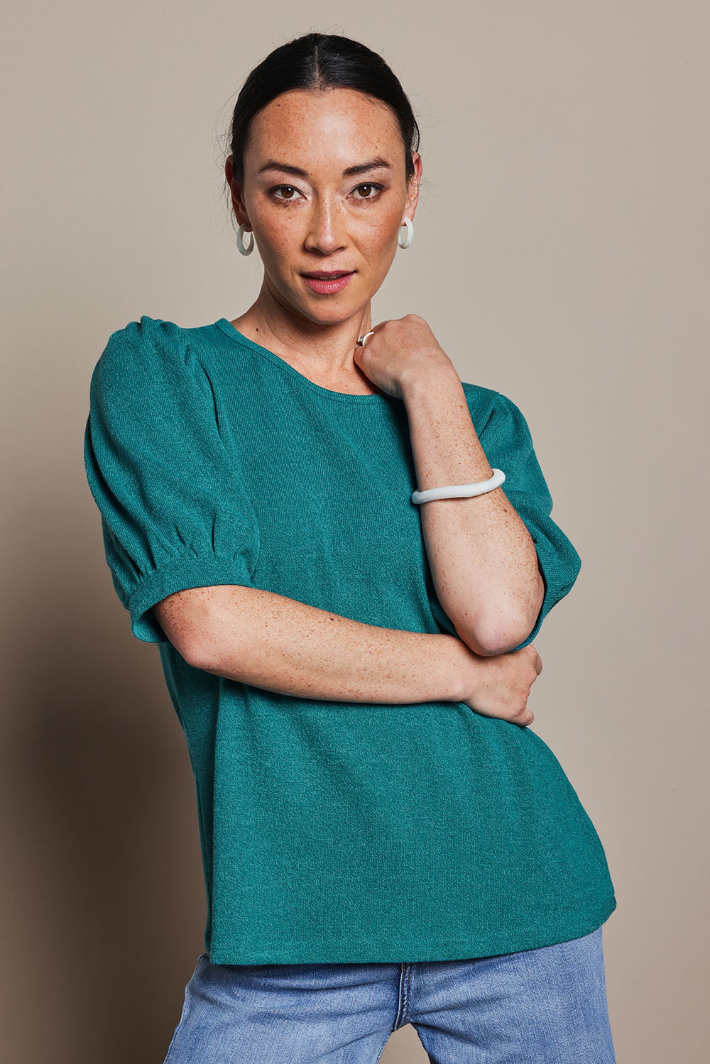 Model Katie wearing size 10 of the Gathered Sleeve Top in colour Jade (Green), from the front, cropped image
