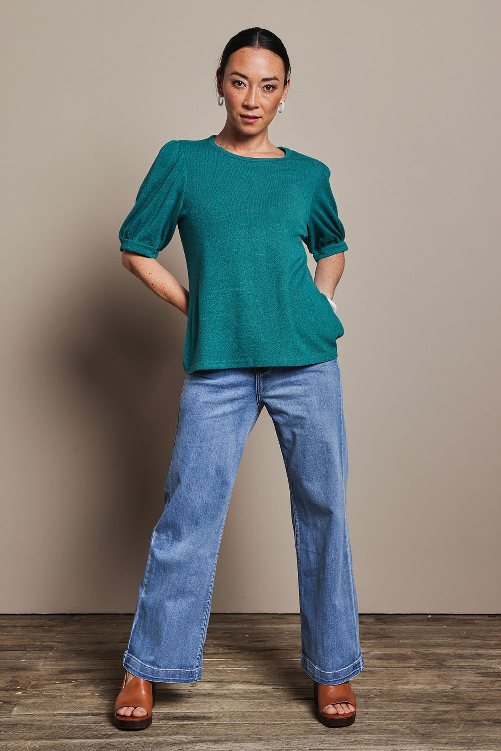 Model Katie wearing size 10 of the Gathered Sleeve Top in colour Jade (Green), from the front, showing the whole outfit