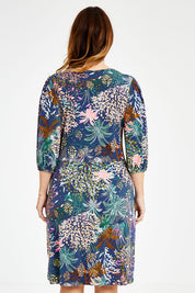 Model Laura wearing size 14 of the Gathered Waist Faux Wrap Dress in colour Wonderland (Blue), from the back