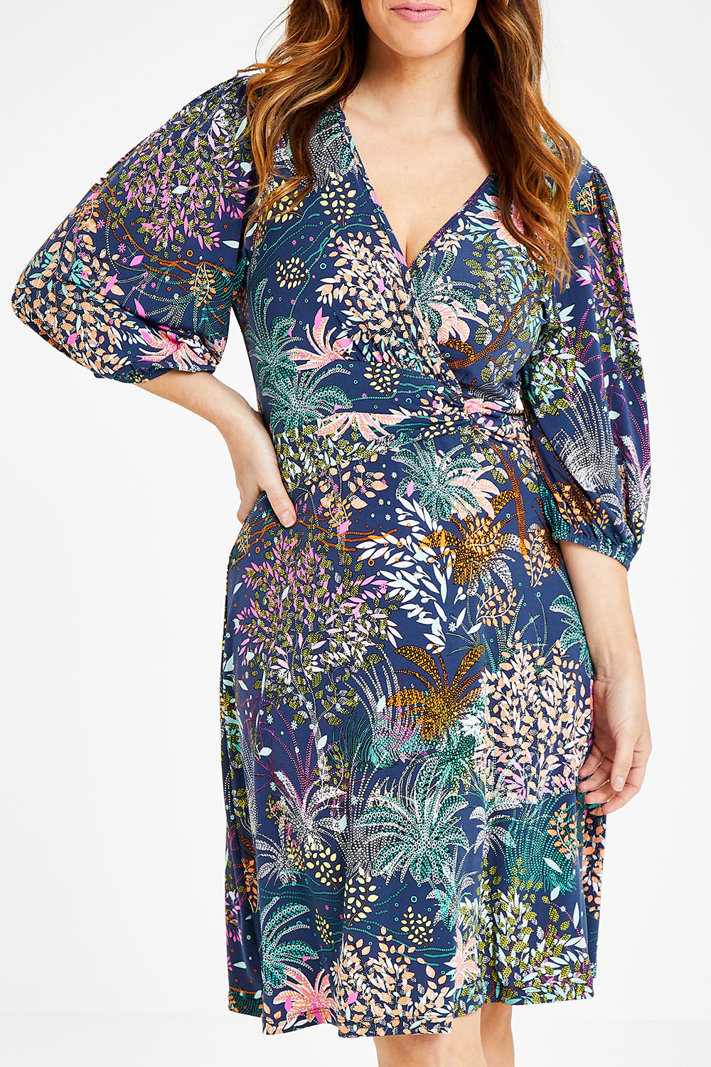 Model Laura wearing size 14 of the Gathered Waist Faux Wrap Dress in colour Wonderland (Blue), from the front, cropped image