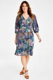 Model Laura wearing size 14 of the Gathered Waist Faux Wrap Dress in colour Wonderland (Blue), from the front, showing the whole outfit