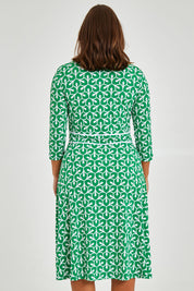 Model Monique wearing size 14 of the Printed 3/4 Sleeve Faux Wrap Dress in colour Petal (Green), from the back