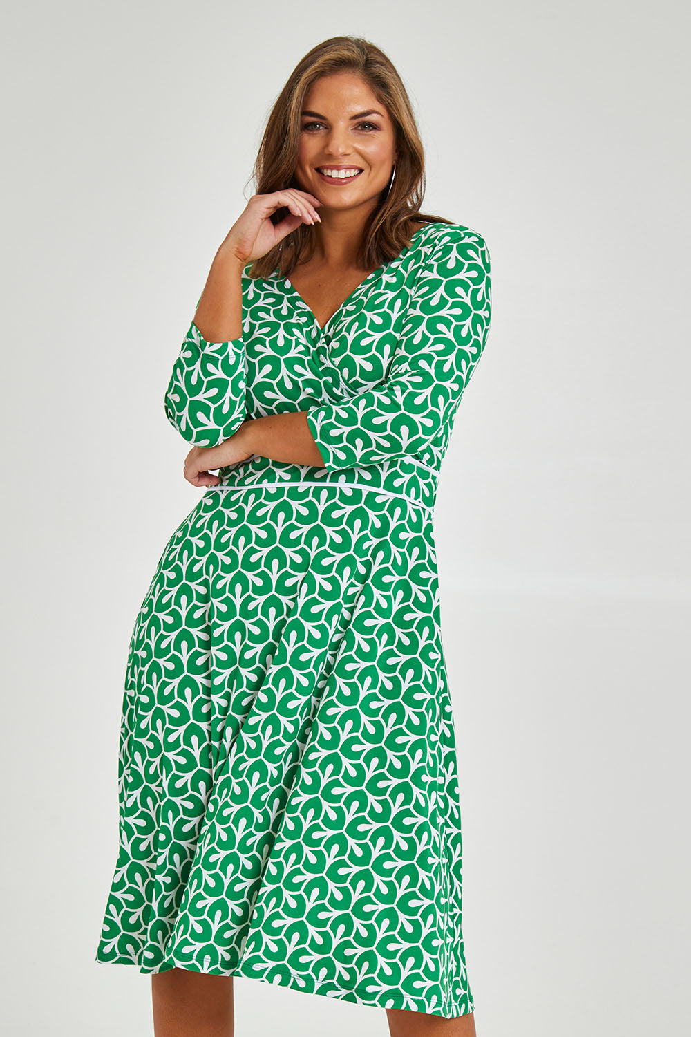 Model Monique wearing size 14 of the Printed 3/4 Sleeve Faux Wrap Dress in colour Petal (Green), from the front, cropped image