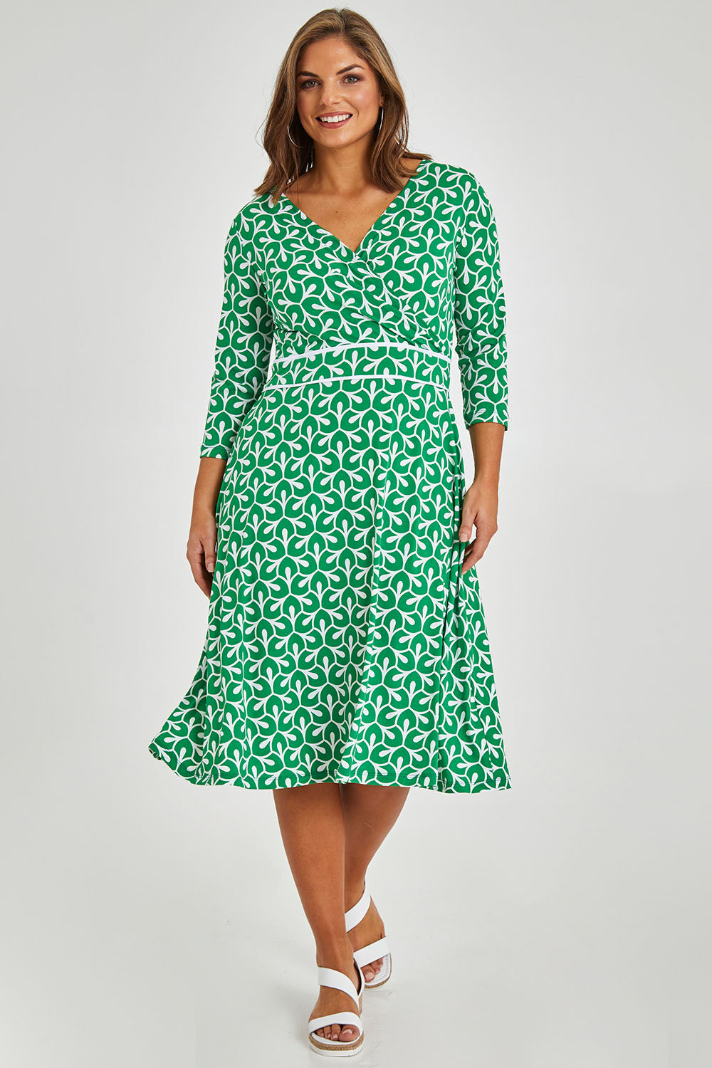 Model Monique wearing size 14 of the Printed 3/4 Sleeve Faux Wrap Dress in colour Petal (Green), from the front, showing the whole outfit