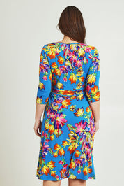 Model Jane wearing size 14 of the Printed 3/4 Sleeve Faux Wrap Dress in colour Garden (Blue), from the back