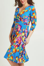 Model Jane wearing size 14 of the Printed 3/4 Sleeve Faux Wrap Dress in colour Garden (Blue), from the front, cropped image