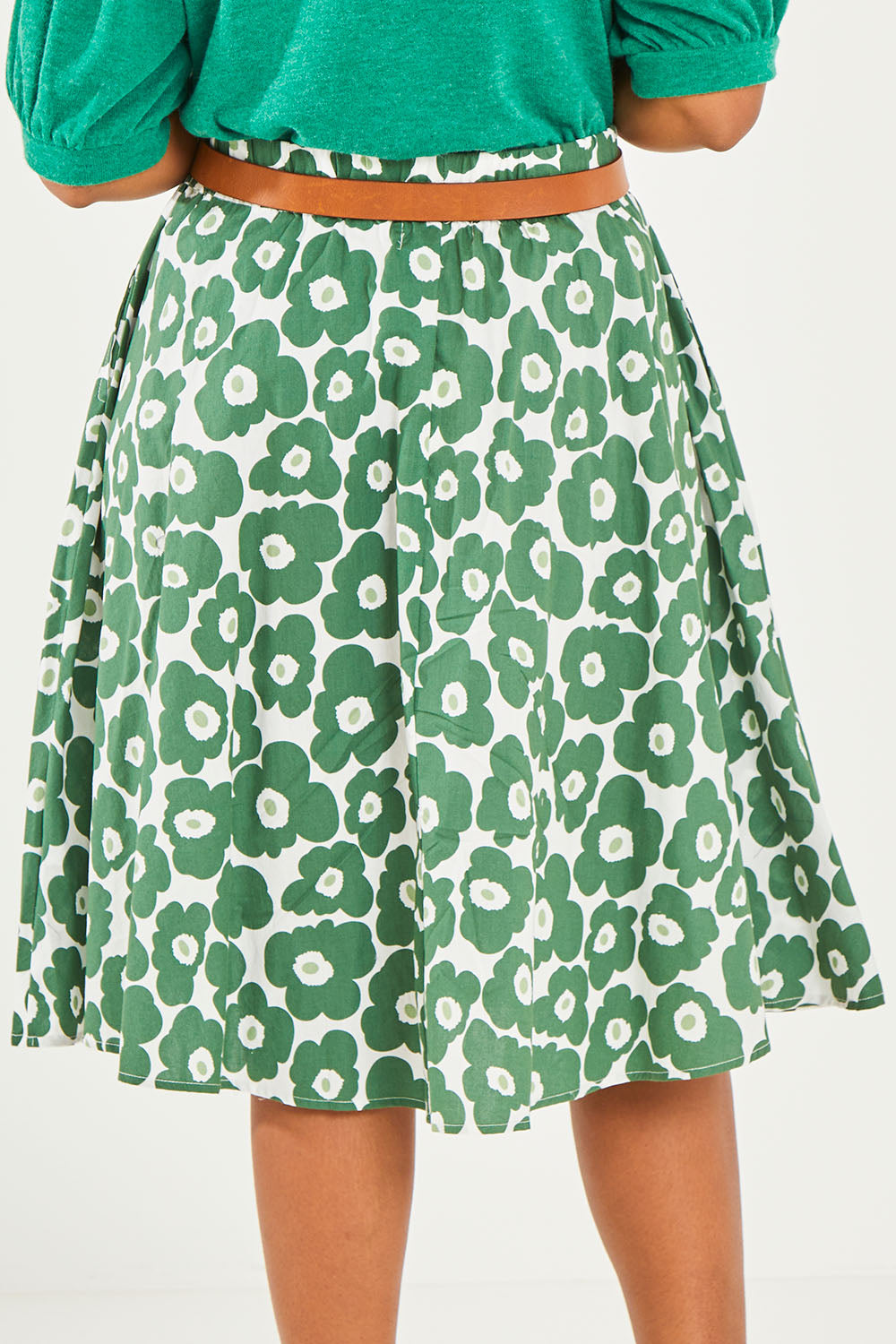 Model Noli wearing size 14 of the Calf Length Gathered Skirt in colour Daisy (Green), from the back