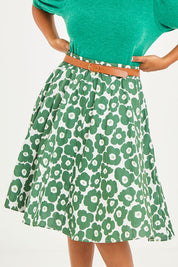 Model Noli wearing size 14 of the Calf Length Gathered Skirt in colour Daisy (Green), from the front, cropped image