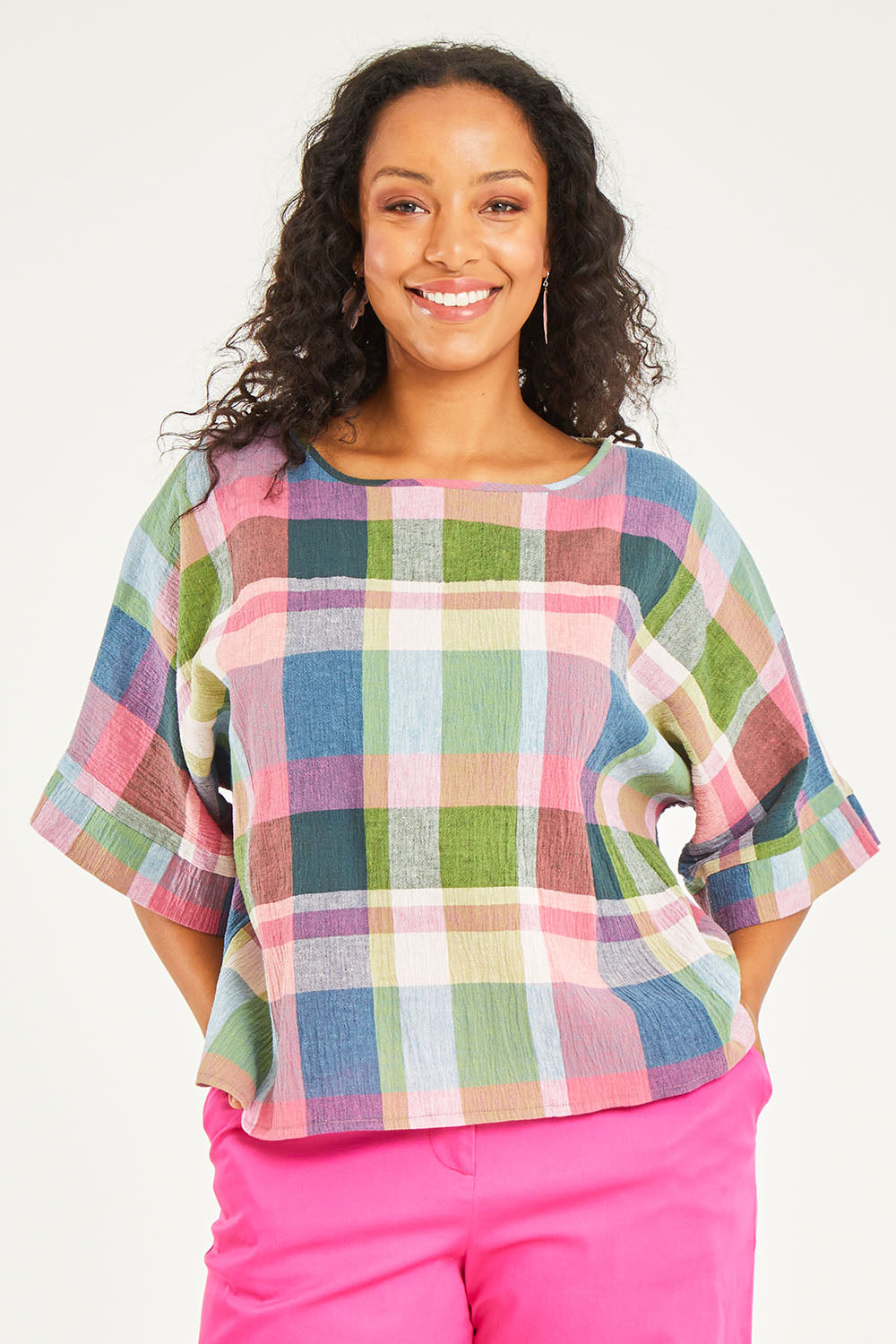 Model Noli wearing size 14 of the Bell Sleeve Top in colour Check (Blue), from the front, cropped image