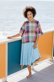 Model Olivia wearing size 10 of the Bell Sleeve Top in colour Check (Blue), from the front, showing the whole outfit