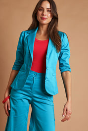 Model Madeline wearing size 10 of the Buttoned Blazer in colour Turquoise (Blue), from the front, showing the whole outfit