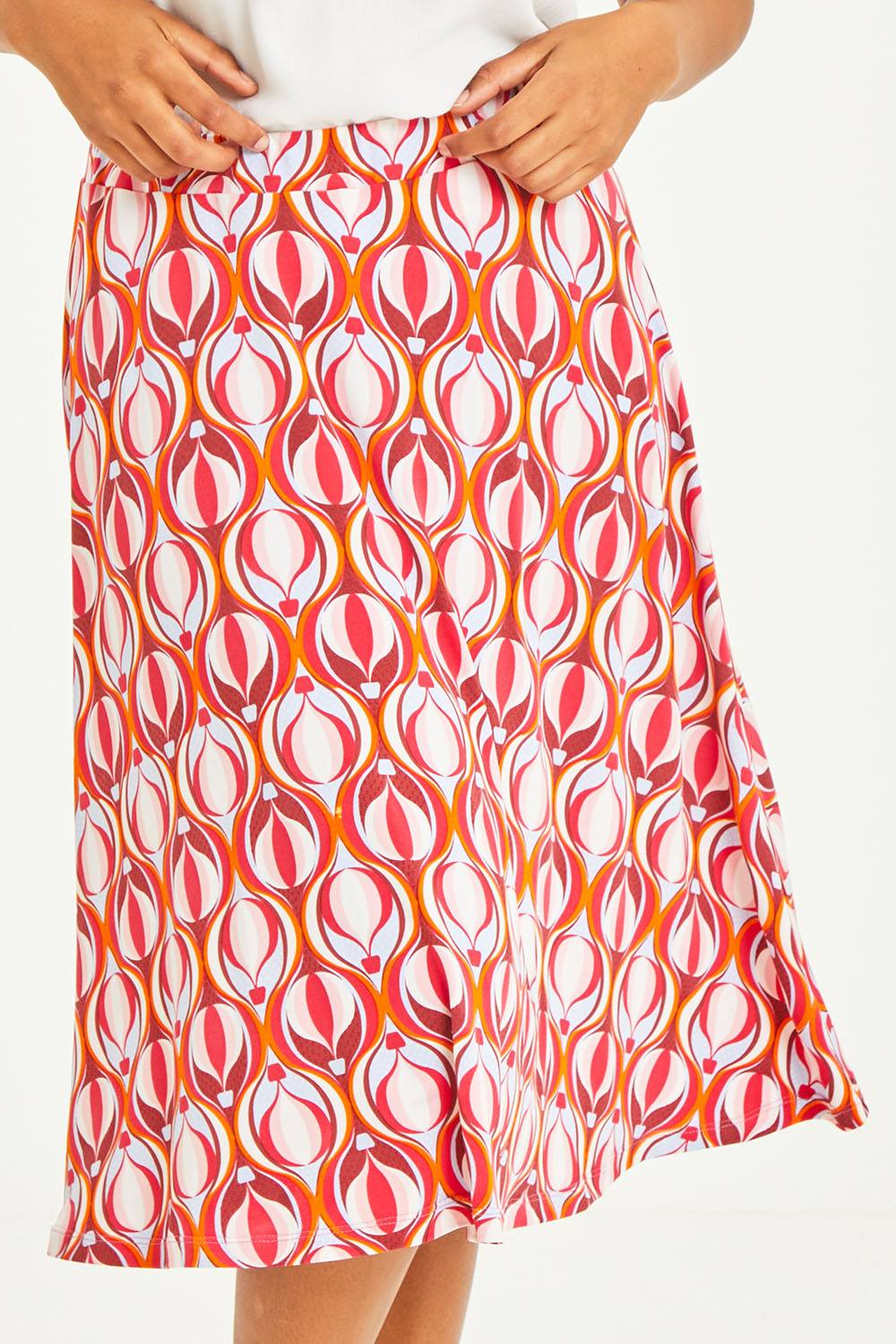 Model Noli wearing size 14 of the Printed Calf Length Gathered Waist Skirt in colour Balloons (Pink), from the front, cropped image