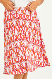 Model Noli wearing size 14 of the Printed Calf Length Gathered Waist Skirt in colour Balloons (Pink), from the front, cropped image