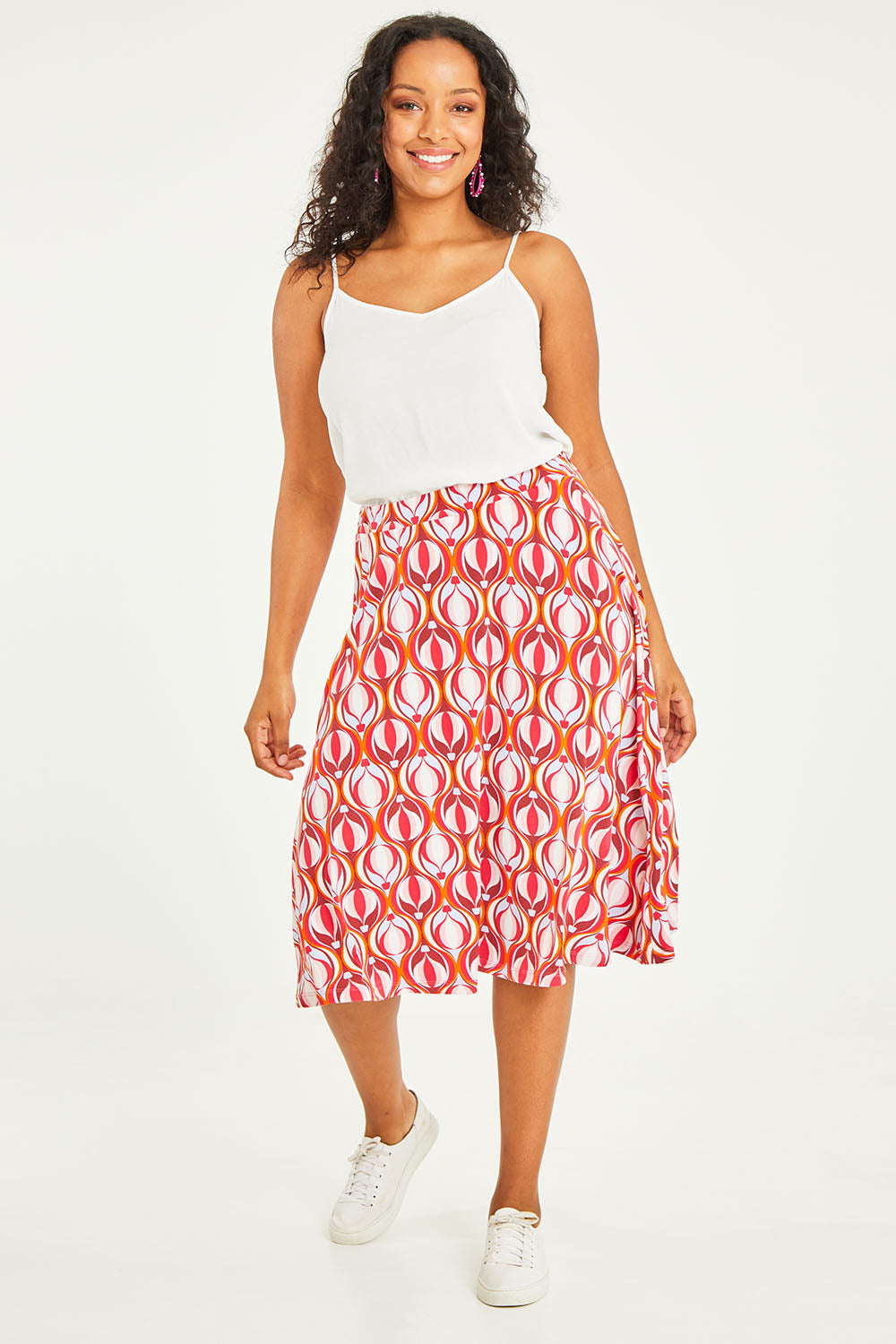 Model Noli wearing size 14 of the Printed Calf Length Gathered Waist Skirt in colour Balloons (Pink), from the front, showing the whole outfit