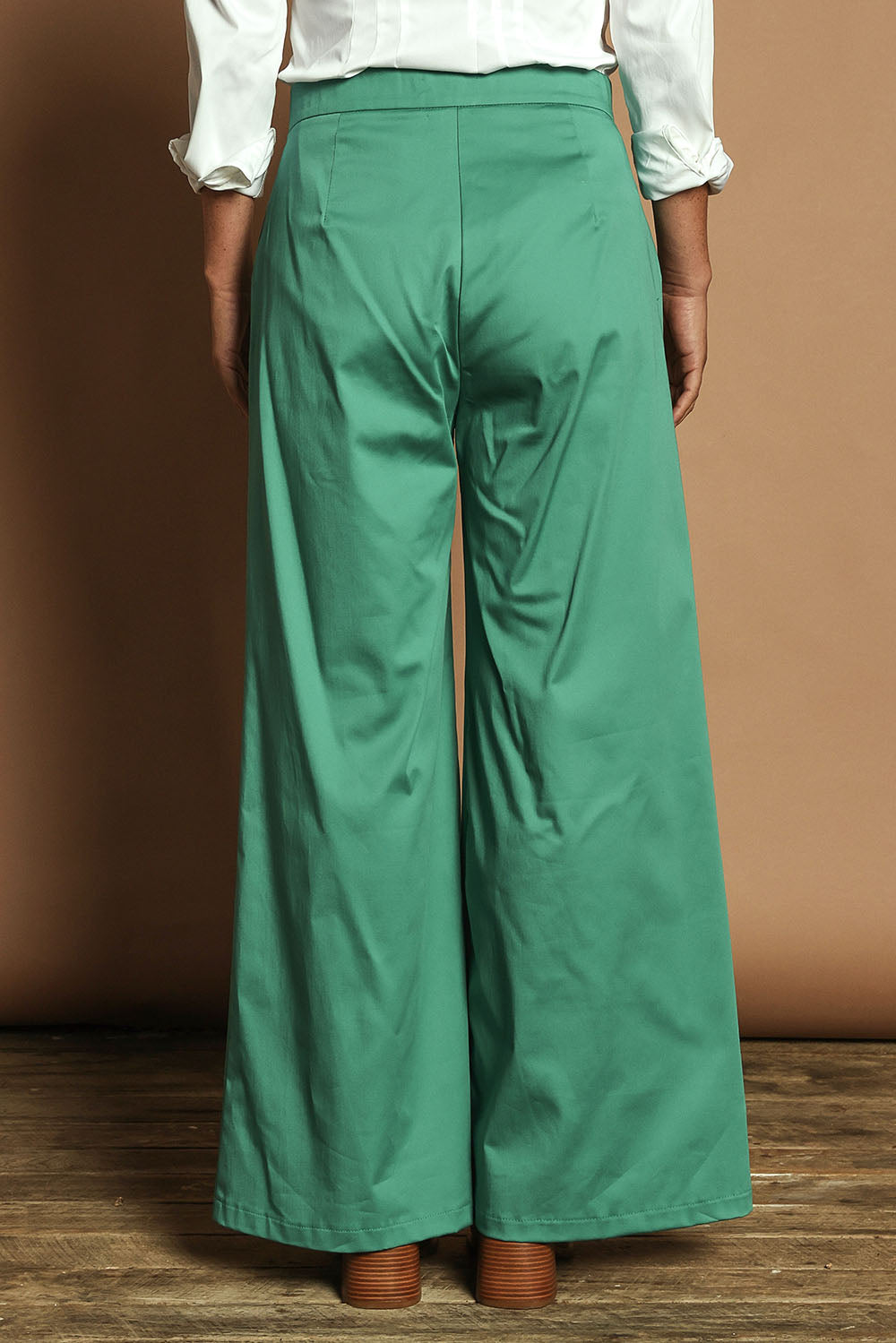 Model Katie wearing size 10 of the Wide Leg Pant in colour Teal (Blue), from the back