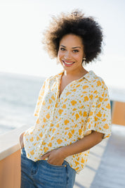 Model Olivia wearing size 10 of the Printed Button Thru Blouse in colour Goldfloral, from the front, showing the whole outfit