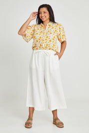 Model Terri-Leigh wearing size 14 of the Printed Button Thru Blouse in colour Goldfloral, from the front, showing the whole outfit