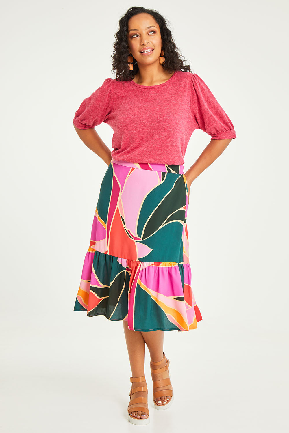 Model Luisa wearing size 14 of the Flitter Skirt in colour Geo (Pink), from the front, showing the whole outfit