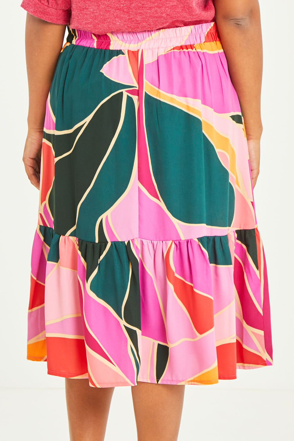 Model Noli wearing size 14 of the Flitter Skirt in colour Geo (Pink), from the back