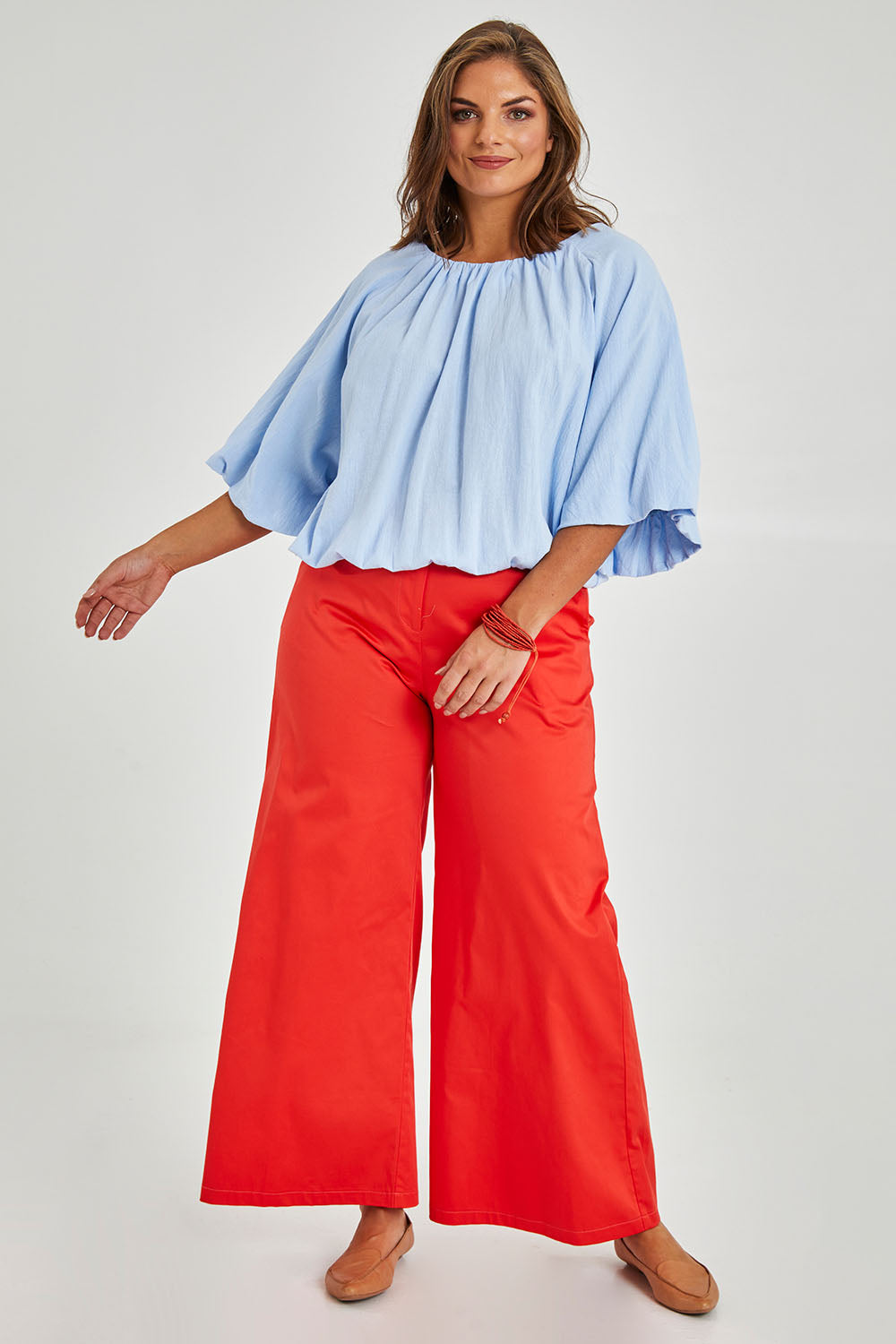Model Monique wearing size 14 of the Billow Sleeve Top in colour Blue (Blue), from the front, showing the whole outfit