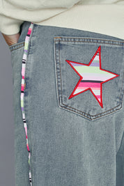 Model Alice wearing size 10 of the Patch Denim High Waisted Jeans in colour Denim (Blue), from the front, cropped image