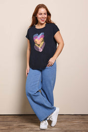 Model Georgiel wearing size 10 of the Heart Logo Tee – Blackpink in colour Blackpink, from the front