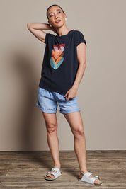 Model Katie wearing size 10 of the Heart Logo Tee in colour Orgheart, from the front, showing the whole outfit