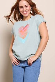 Model Georgiel wearing size 10 of the Heart Logo Tee – Tealred in colour Tealred, in a cropped view