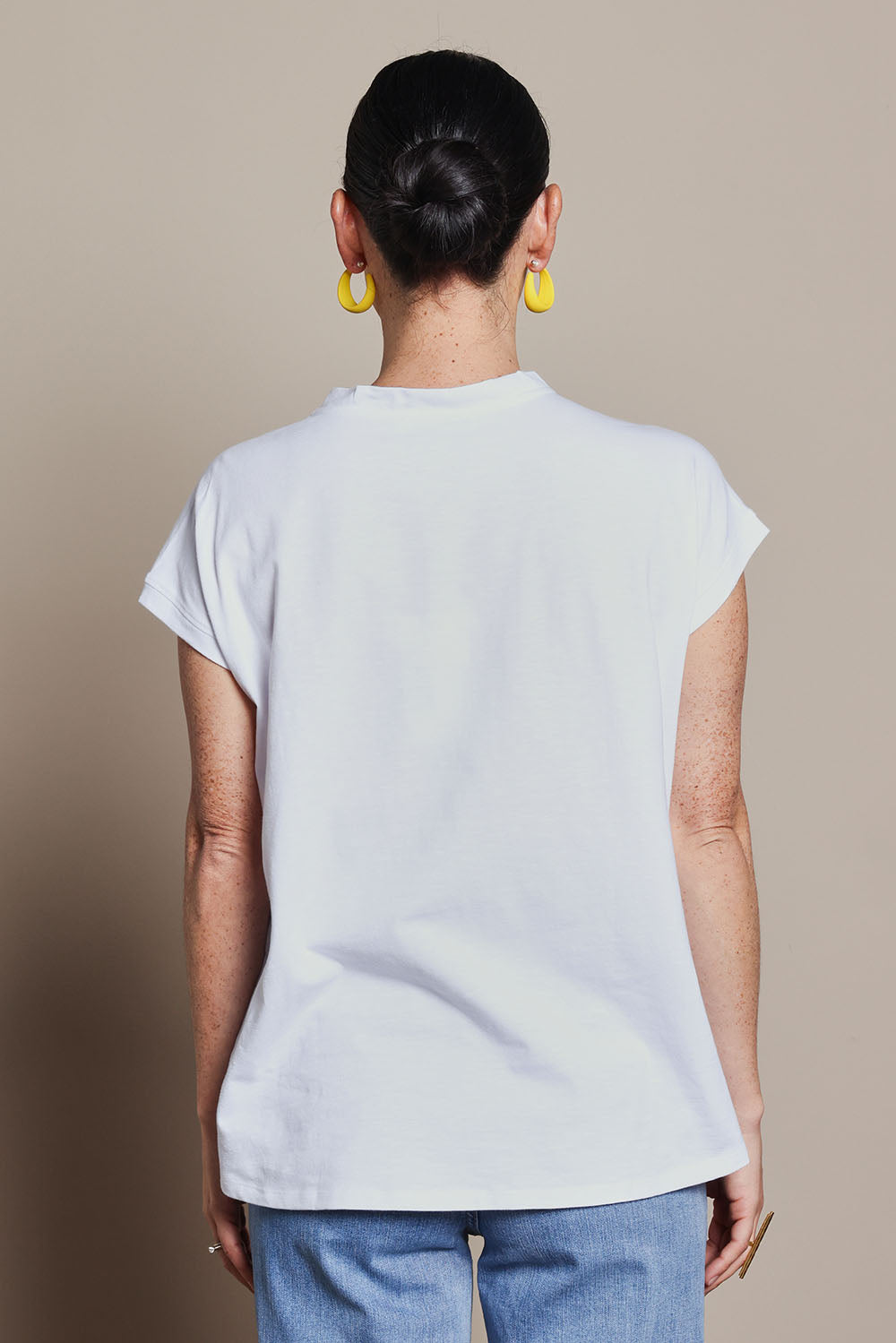 Model Katie wearing size 10 of the Heart Logo Tee in colour Yelloheart, from the back