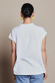 Model Katie wearing size 10 of the Heart Logo Tee in colour Yelloheart, from the back