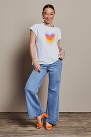 Model Katie wearing size 10 of the Heart Logo Tee in colour Yelloheart, from the front, showing the whole outfit