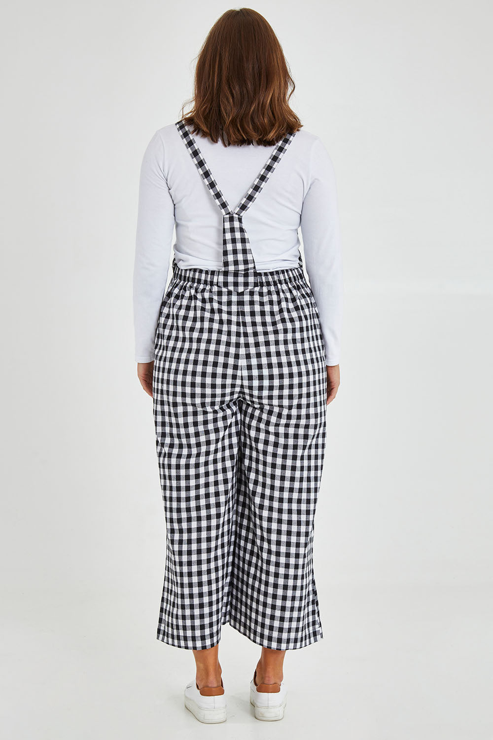 Model Monique wearing size 14 of the Cropped Overalls in colour Blackwhite (Black), from the back