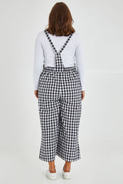 Model Monique wearing size 14 of the Cropped Overalls in colour Blackwhite (Black), from the back