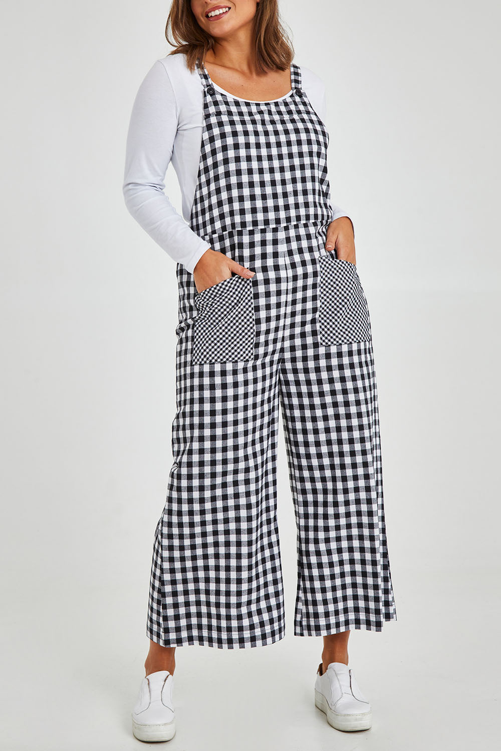 Model Monique wearing size 14 of the Cropped Overalls in colour Blackwhite (Black), from the front, cropped image