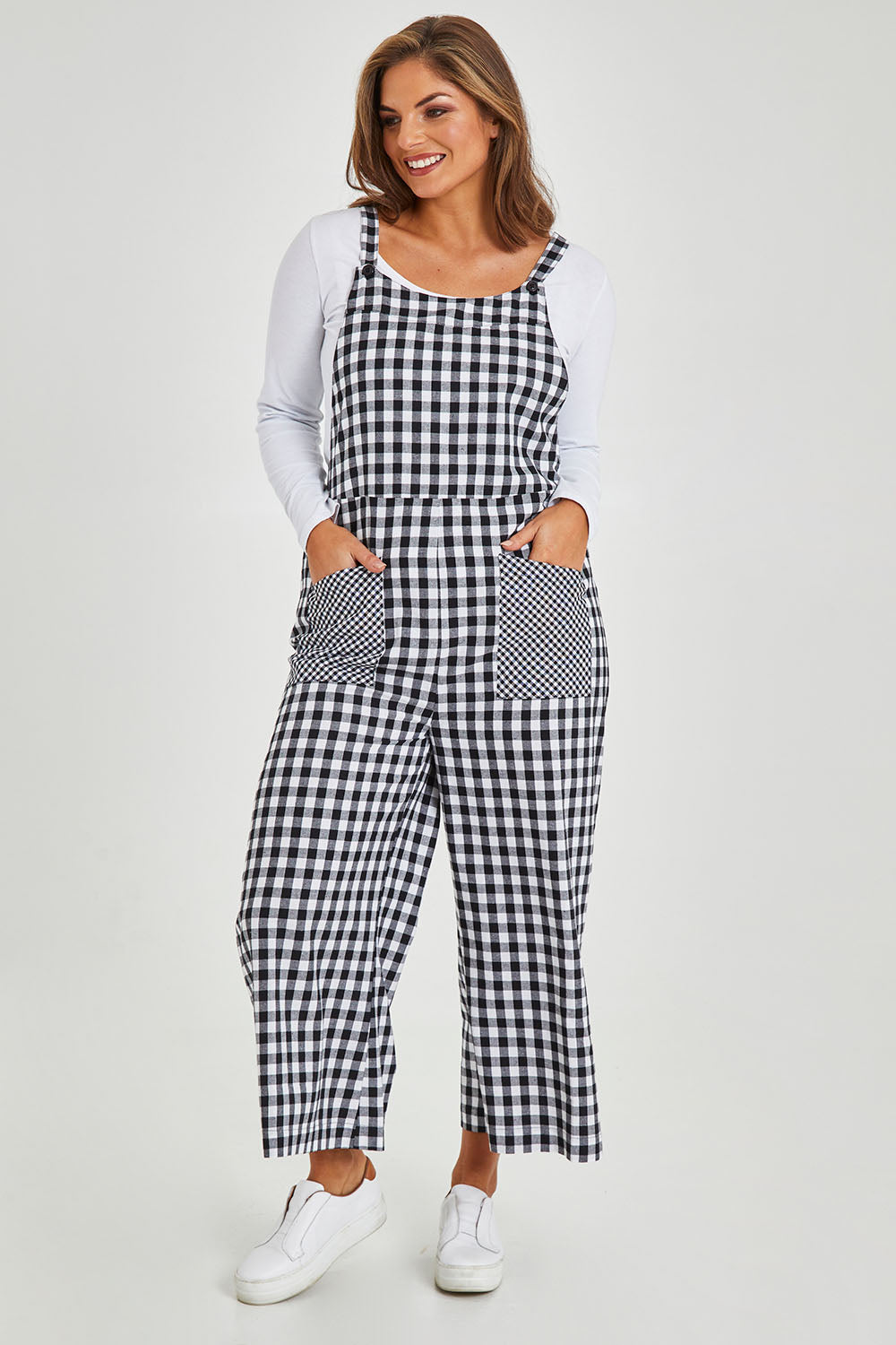 Model Monique wearing size 14 of the Cropped Overalls in colour Blackwhite (Black), from the front, showing the whole outfit