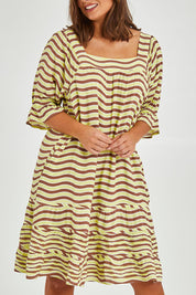 Model Monique wearing size 14 of the Stitch Detail Ruffle Sleeve Dress in colour Limechoc, from the front, cropped image