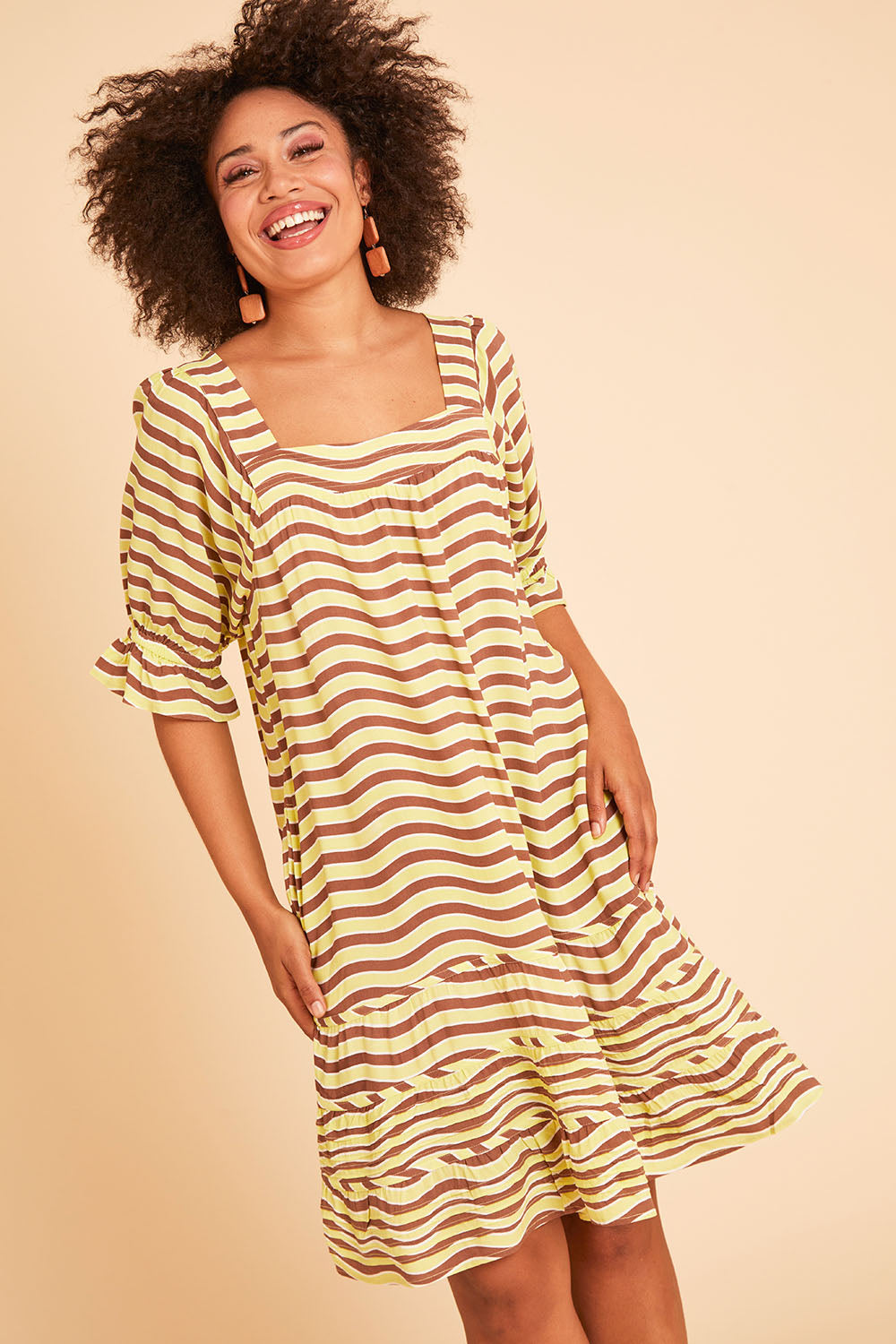 Model Olivia wearing size 10 of the Stitch Detail Ruffle Sleeve Dress in colour Limechoc, from the front, showing the whole outfit