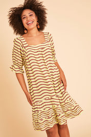 Model Olivia wearing size 10 of the Stitch Detail Ruffle Sleeve Dress in colour Limechoc, from the front, showing the whole outfit