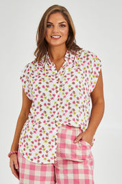 Model Monique wearing size 14 of the Cap Sleeve Shirt in colour Retrodaisy (White), from the front, cropped image