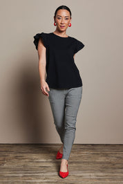 Model Katie wearing size 10 of the Ruffle Sleeve Top in colour Black (Black), from the front, showing the whole outfit