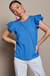Model Katie wearing size 10 of the Ruffle Sleeve Top in colour Frenchblue (Blue), from the front, cropped image