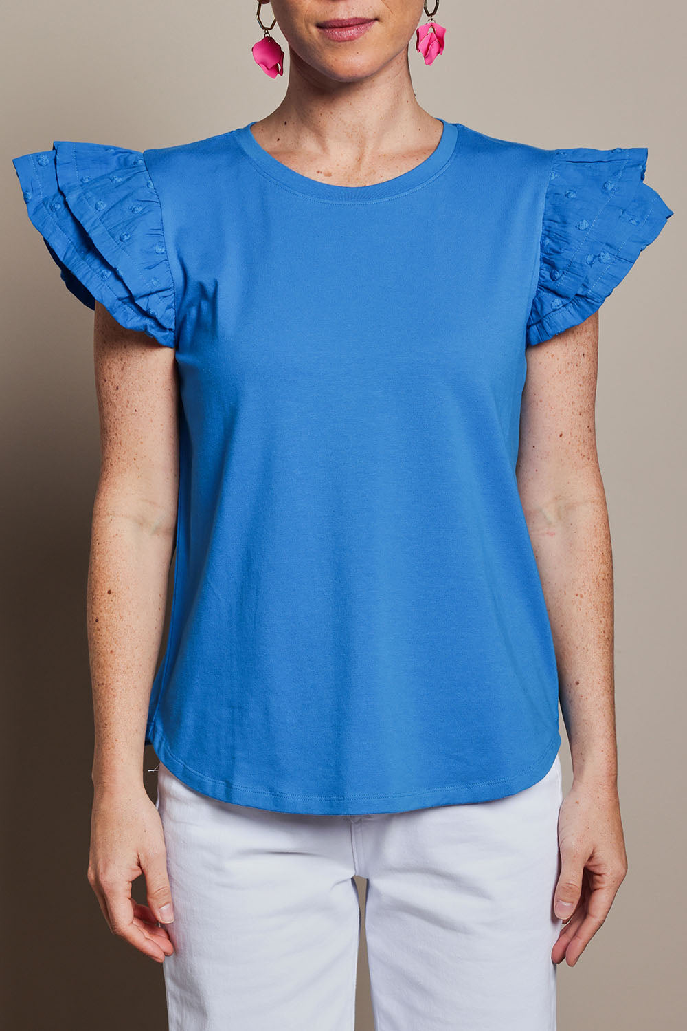 Model Katie wearing size 10 of the Ruffle Sleeve Top in colour Frenchblue (Blue), from the front, cropped image