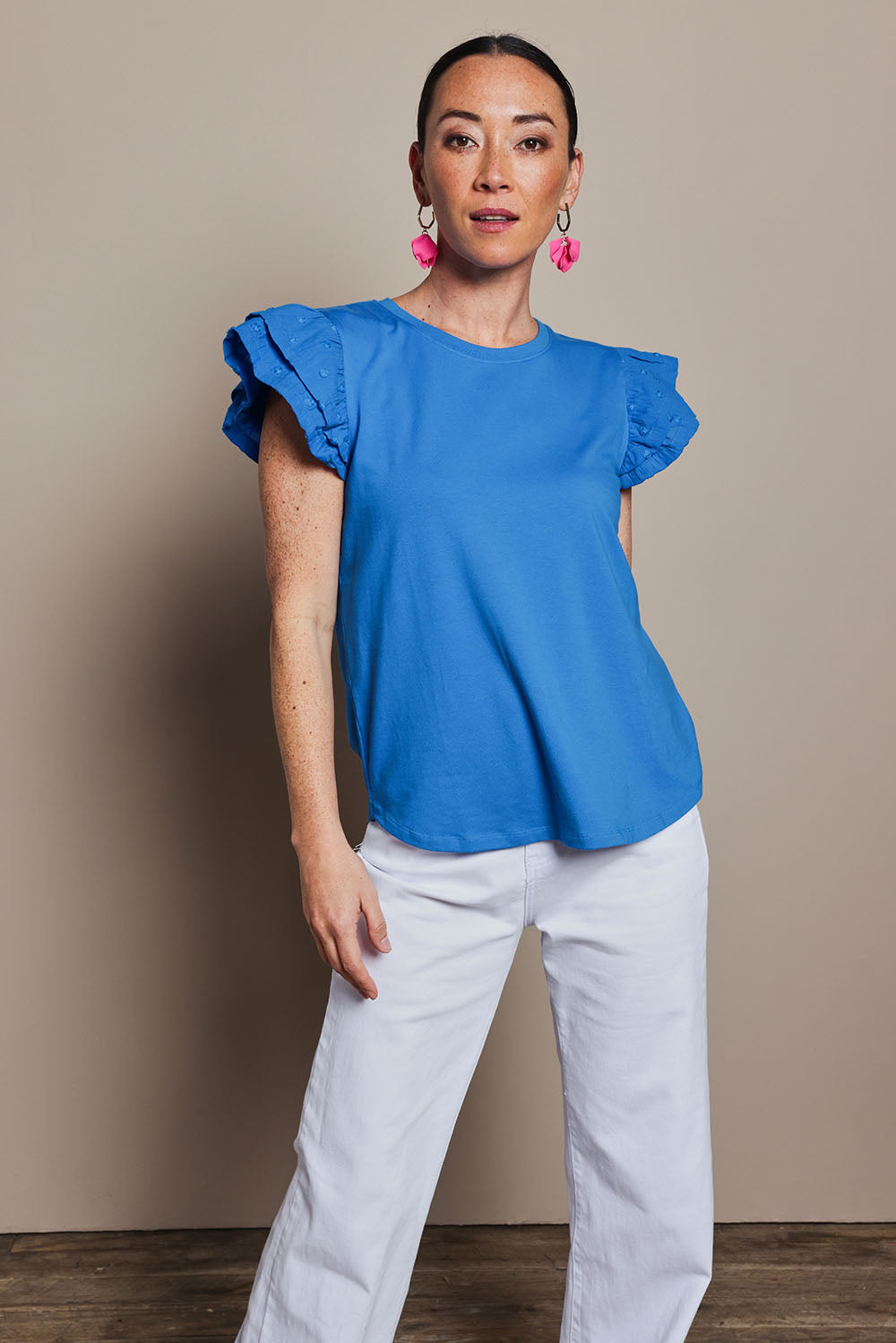 Model Katie wearing size 10 of the Ruffle Sleeve Top in colour Frenchblue (Blue), from the front, cropped image