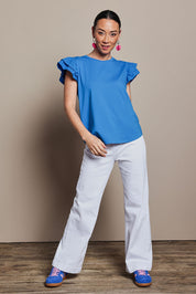 Model Katie wearing size 10 of the Ruffle Sleeve Top in colour Frenchblue (Blue), from the front, showing the whole outfit