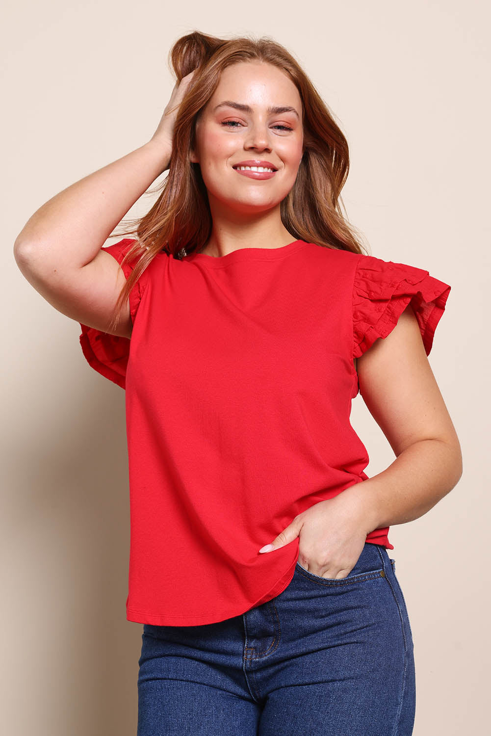 Model Georgiel wearing size 10 of the Ruffle Sleeve Top – Lollipop in colour Lollipop, in a cropped view