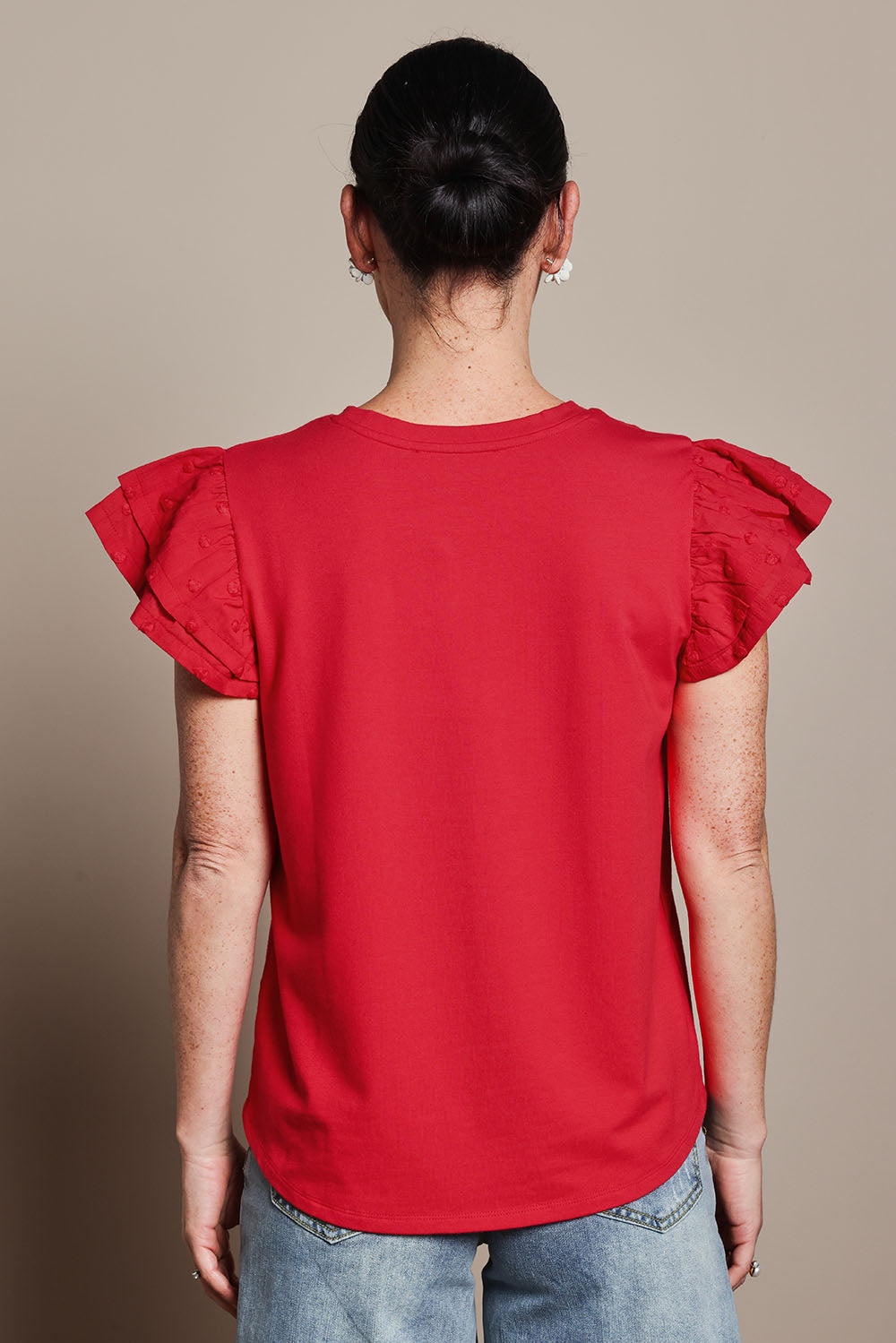 Model Katie wearing size 10 of the Ruffle Sleeve Top in colour Lollipop (Red), from the back