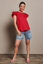 Model Katie wearing size 10 of the Ruffle Sleeve Top in colour Lollipop (Red), from the front, showing the whole outfit
