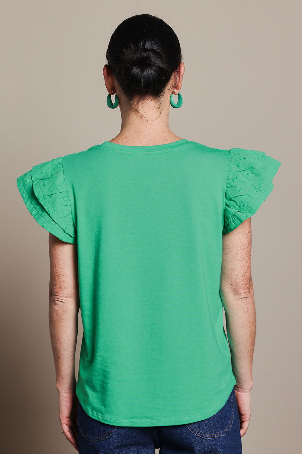 Model Katie wearing size 10 of the Ruffle Sleeve Top in colour Mint (Green), from the back